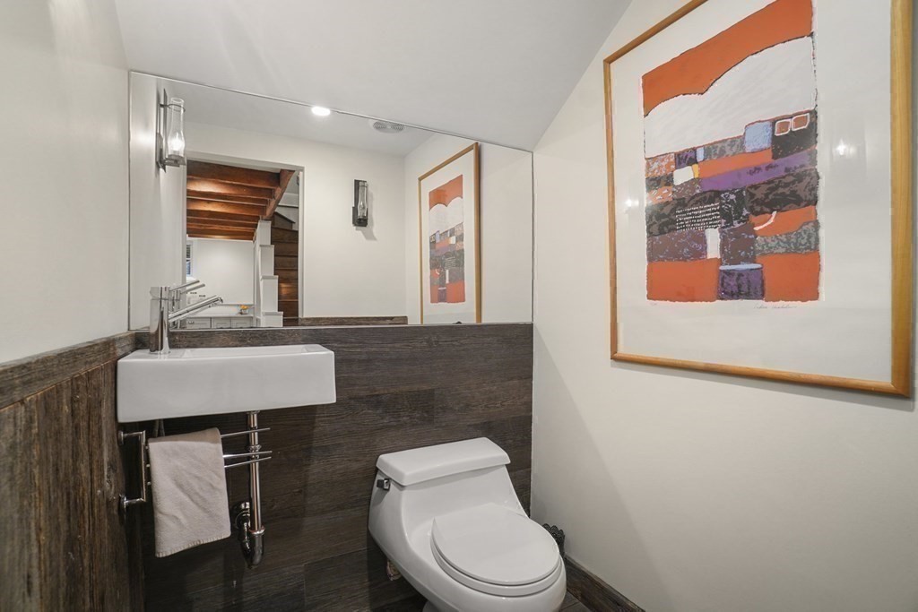6 Strong Place Boston, MA 02114 - Photo 21 of 38 a bathroom with a toilet a sink and mirror