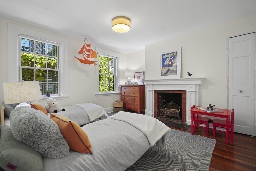 6 Strong Place Boston, MA 02114 - Photo 29 of 38 a bedroom with a bed and a fireplace