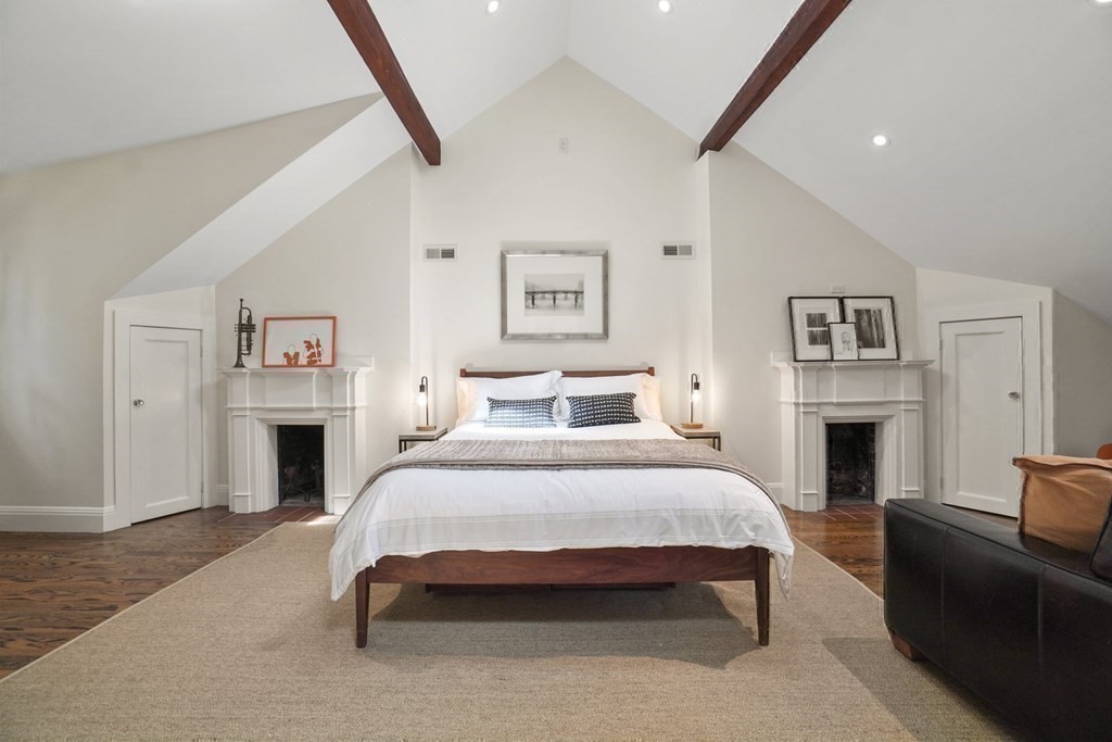6 Strong Place Boston, MA 02114 - Photo 32 of 38 a spacious bedroom with a bed and a fireplace