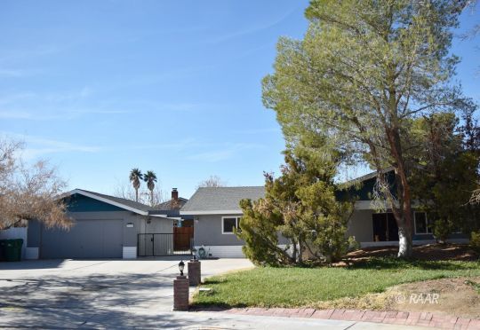 313 South Lilac Street Ridgecrest, CA 93555 - Photo 1 of 26 a front view of a house with a yard