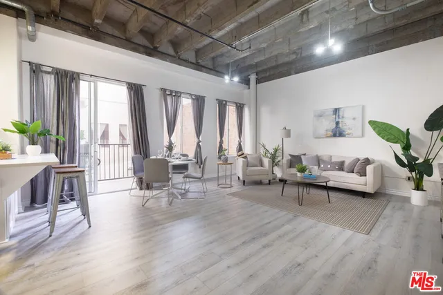 a living room with furniture and large windows