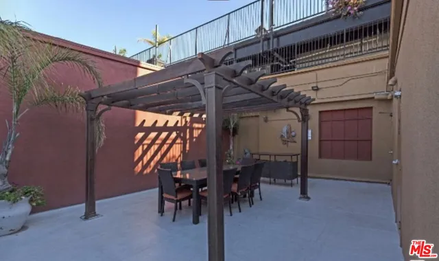 a living room with furniture and large windows
