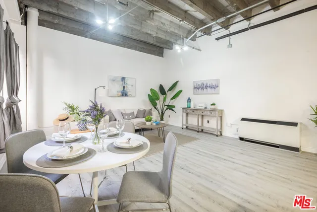 a dining room with furniture and wooden floor