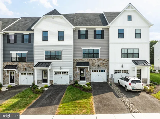 a kitchen with stainless steel appliances granite countertop a kitchen island a stove a table and chairs