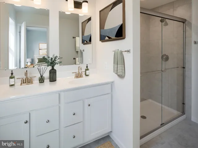 a bathroom with a shower sink and mirror