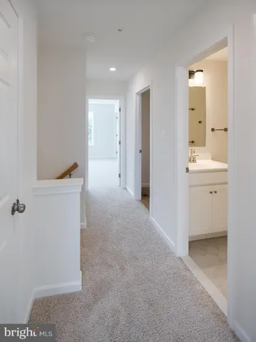 a view of a room with an empty space and a hallway