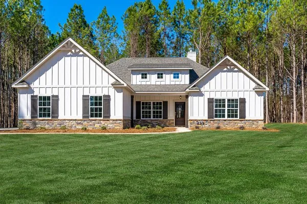 a front view of a house with a yard and porch