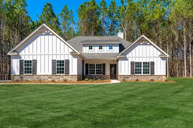 a front view of a house with a yard and porch