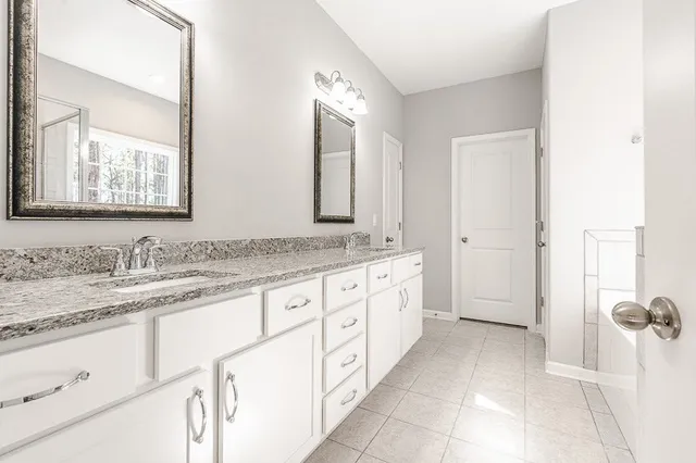 a bathroom with a granite countertop sink mirror and