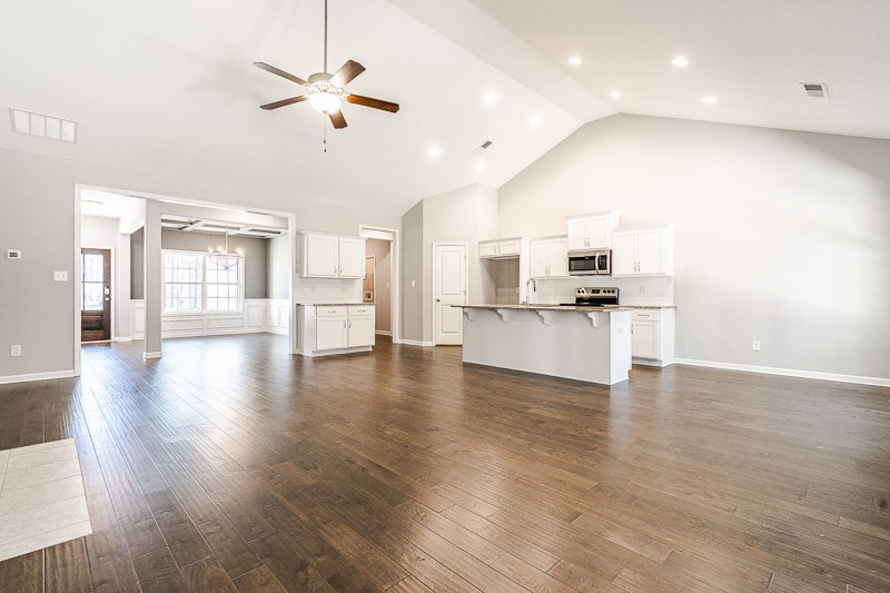 32 Maple Lakes Drive Cataula, GA 31804 - Photo 6 of 27 a view of an empty room and kitchen with wooden floor
