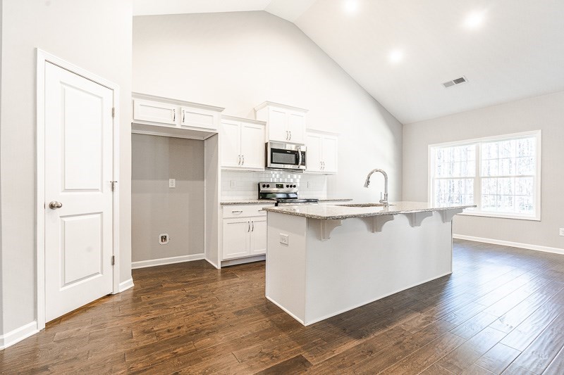 32 Maple Lakes Drive Cataula, GA 31804 - Photo 8 of 27 a living room with stainless steel appliances a kitchen island hardwood floor and a window