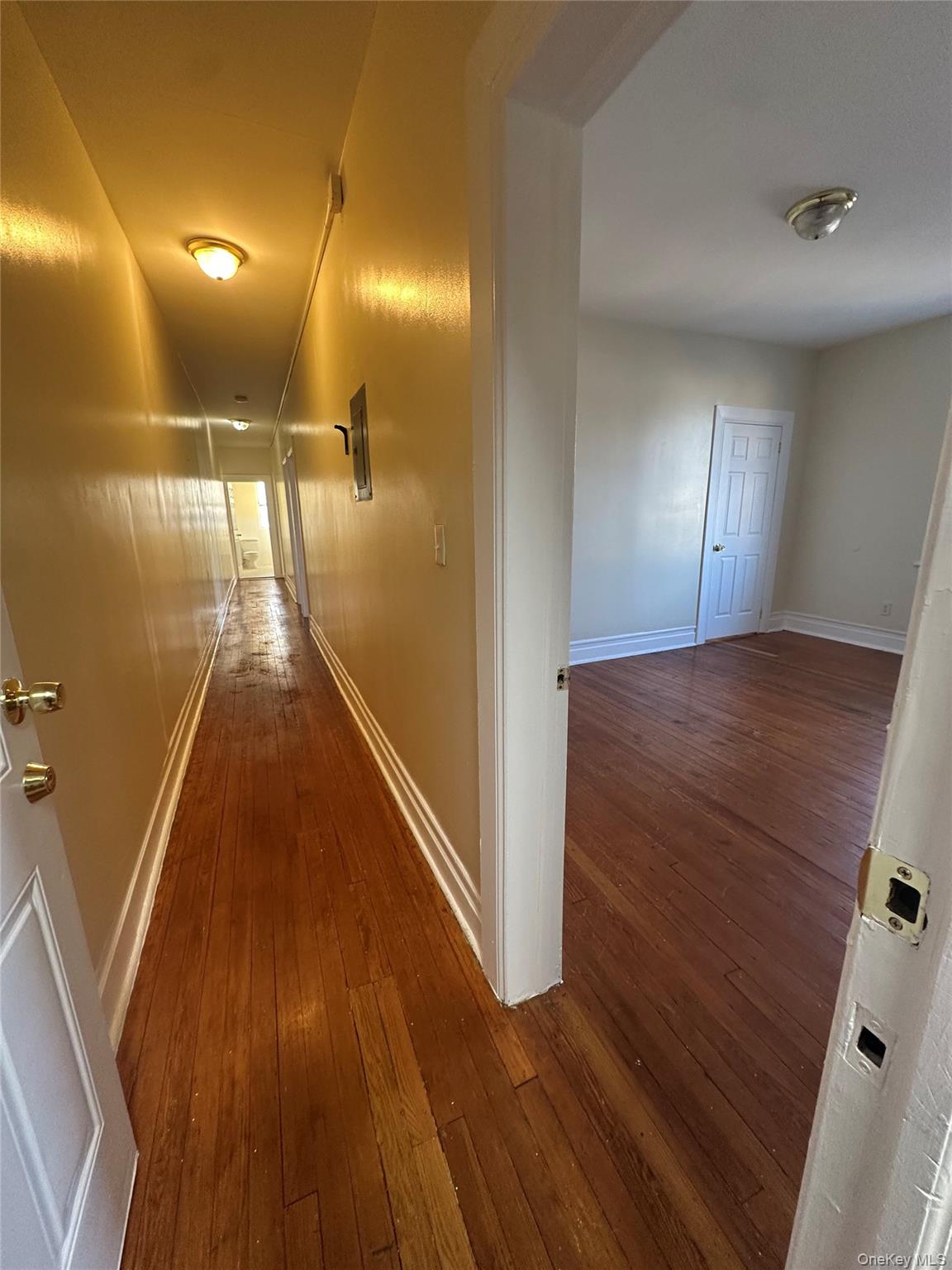 22 Clove Road New Rochelle, NY 10801 - Photo 11 of 11 a view of a hallway with wooden floor