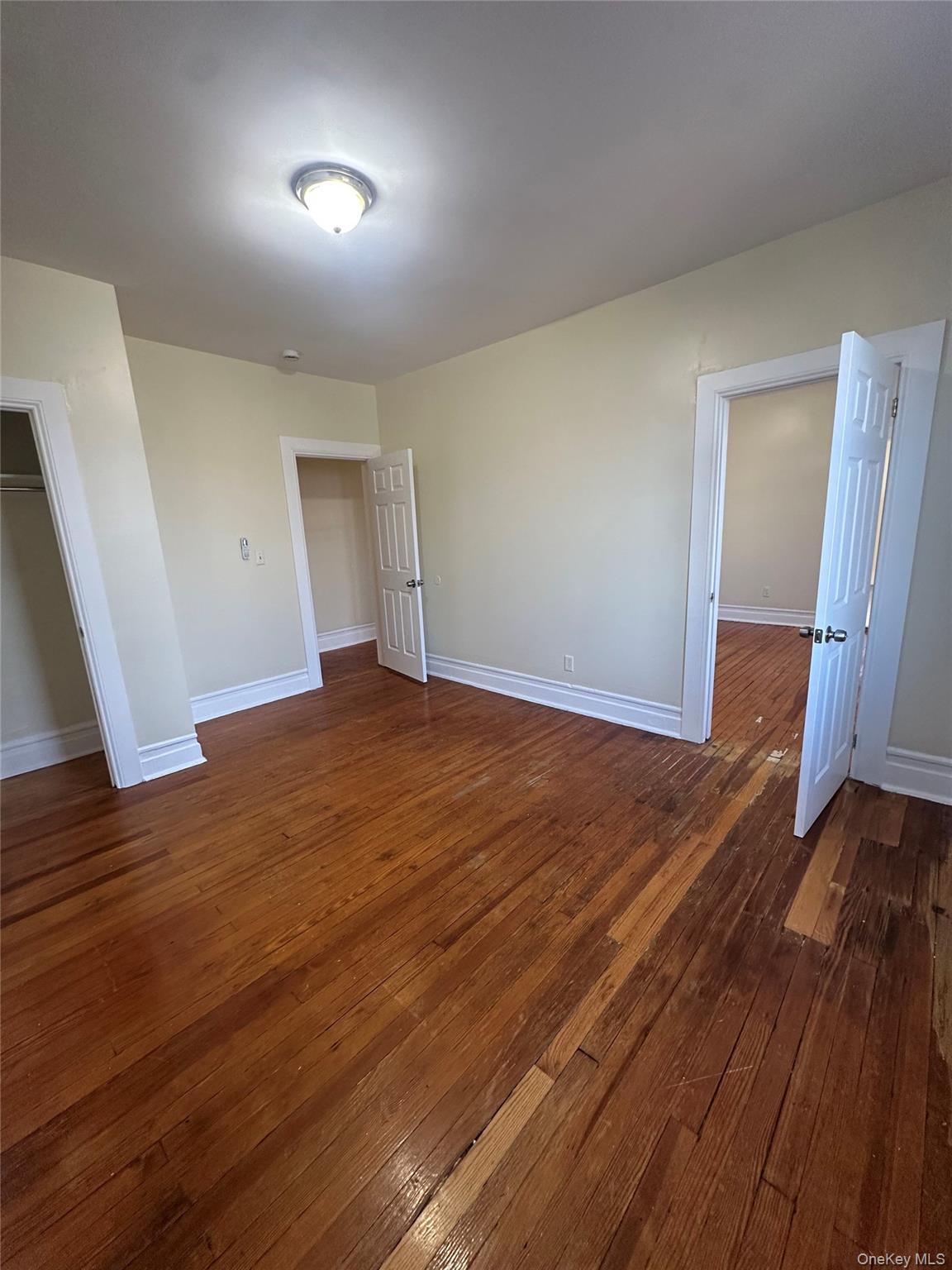 22 Clove Road New Rochelle, NY 10801 - Photo 4 of 11 wooden floor in an empty room with a window