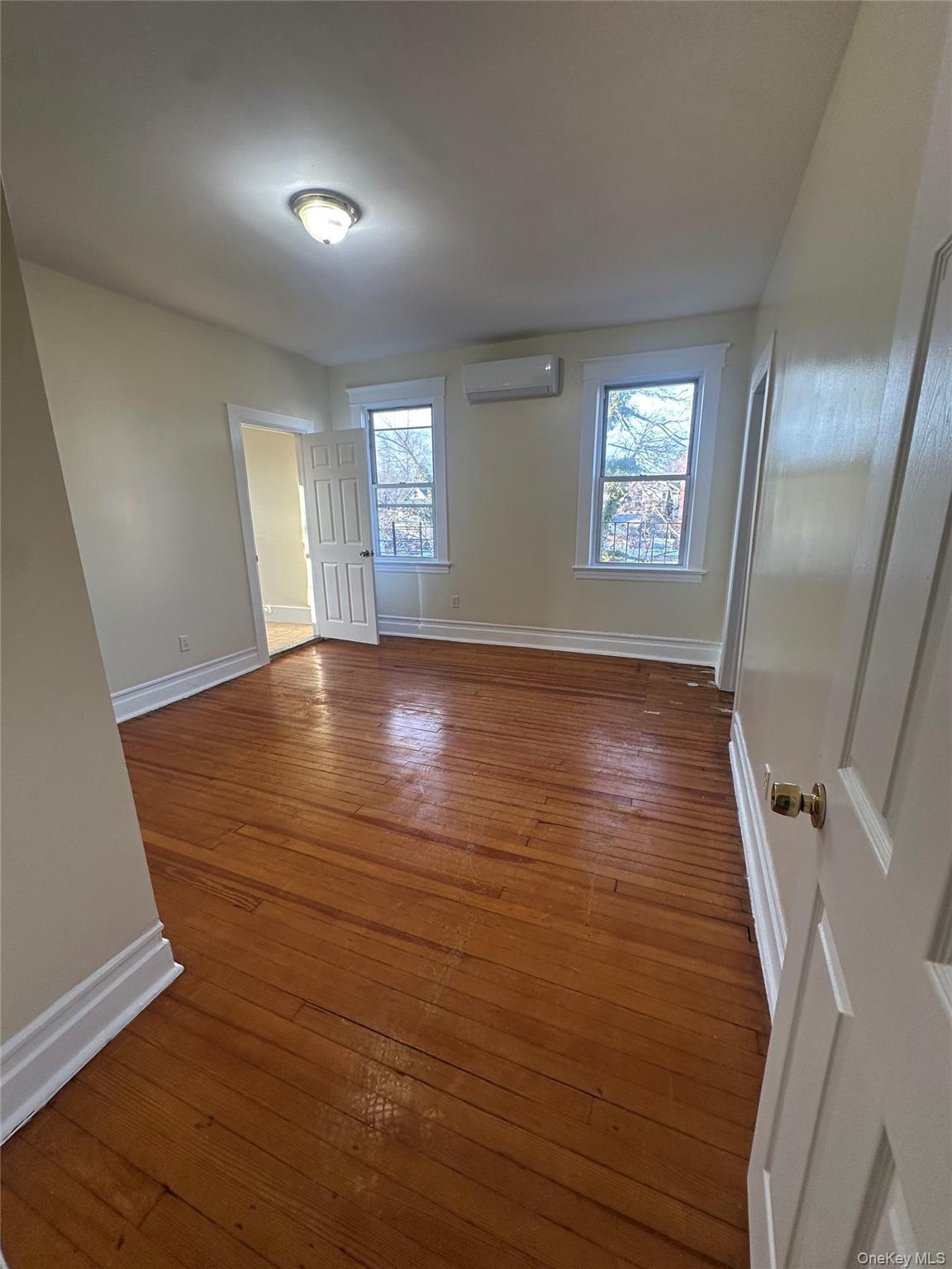 22 Clove Road New Rochelle, NY 10801 - Photo 9 of 11 wooden floor in an empty room with a window