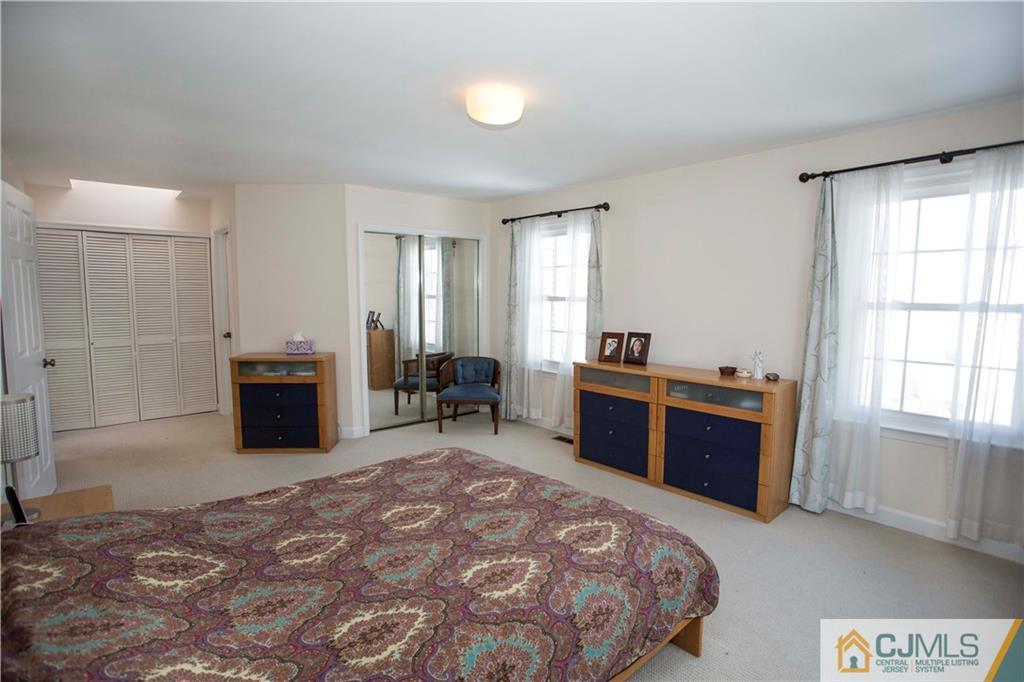 3806 Springbrook Drive Edison, NJ 08820 - Photo 11 of 22 a bedroom with a bed and a television