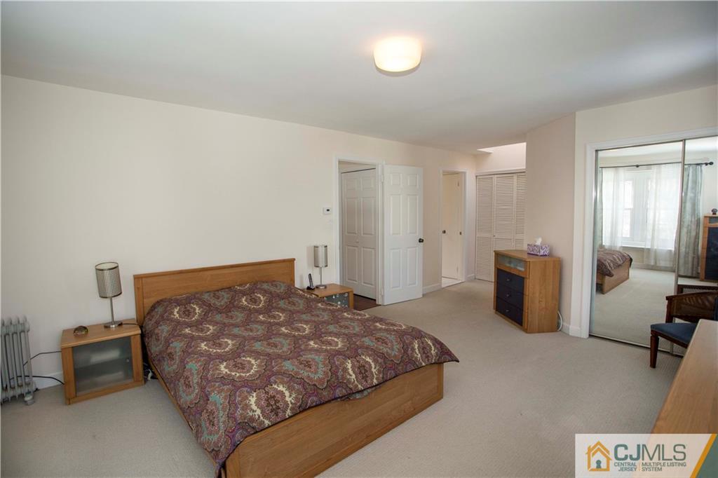 3806 Springbrook Drive Edison, NJ 08820 - Photo 12 of 22 a bedroom with a bed and a couch