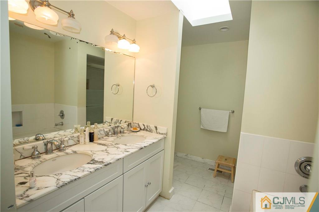 3806 Springbrook Drive Edison, NJ 08820 - Photo 14 of 22 a bathroom with a granite countertop sink mirror and double
