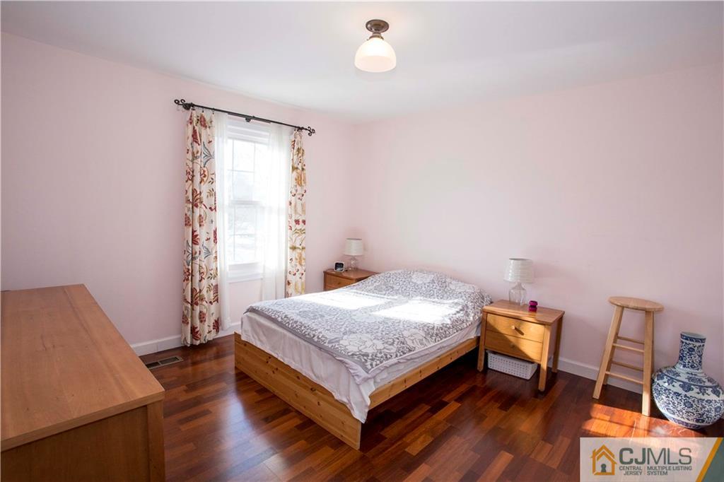 3806 Springbrook Drive Edison, NJ 08820 - Photo 15 of 22 a bedroom with a bed and a table in it