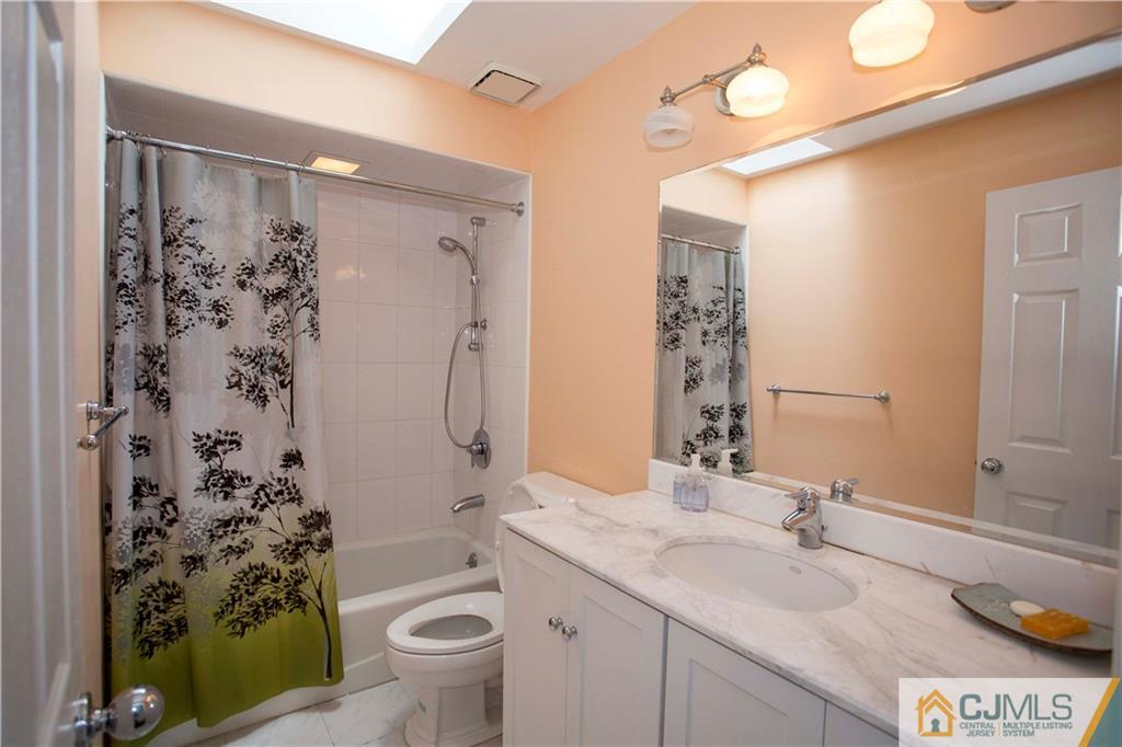 3806 Springbrook Drive Edison, NJ 08820 - Photo 17 of 22 a bathroom with a granite countertop sink toilet and shower
