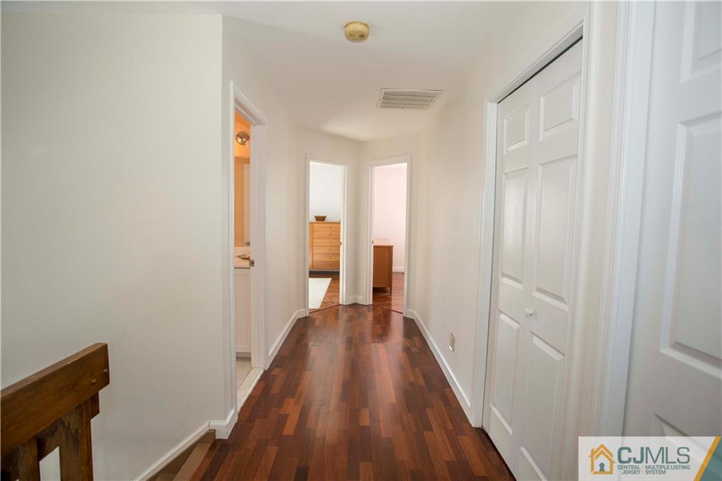 3806 Springbrook Drive Edison, NJ 08820 - Photo 18 of 22 a view of a hallway with wooden floor