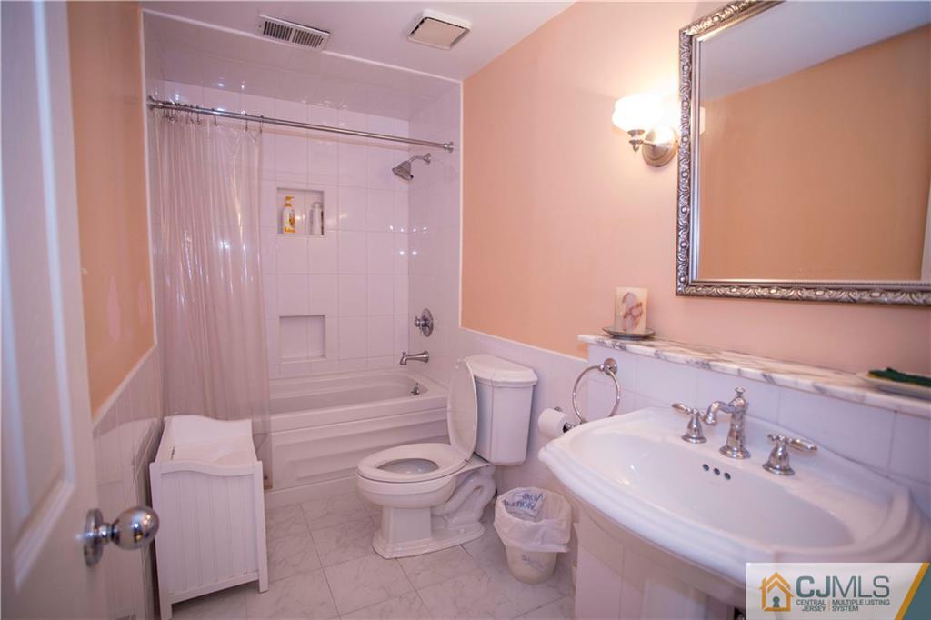 3806 Springbrook Drive Edison, NJ 08820 - Photo 20 of 22 a bathroom with a sink toilet and shower