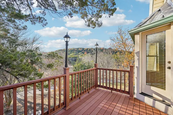 a view of a balcony with wooden floor and fence