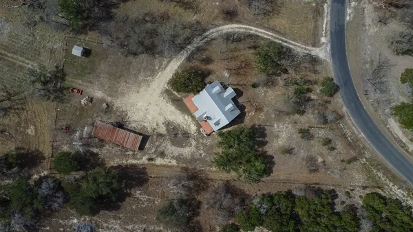 an aerial view of a house with a yard
