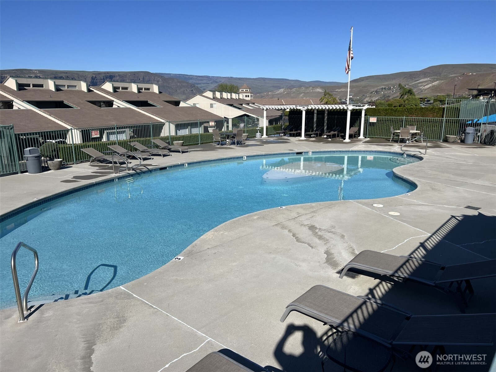 8997 Crescent Bar Road Northwest, Unit C118 Quincy, WA 98848 - Photo 31 of 33 a view of a swimming pool with outdoor seating