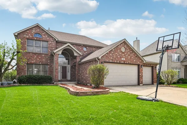 a front view of a house with a yard and garage