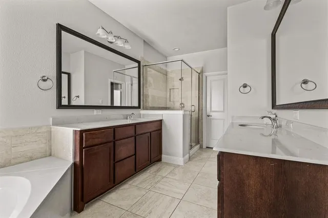 a spacious bathroom with a sink and a mirror
