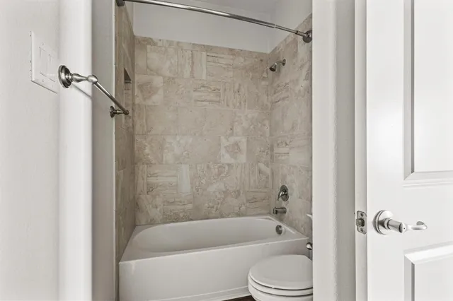 a bathroom with a shower a bathtub and a shower
