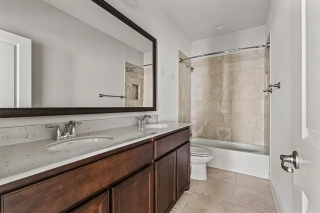 a bathroom with a double vanity sink mirror double and a bathtub