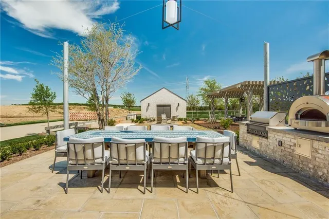 a view of a patio with table and chairs potted plants with wooden floor and fence