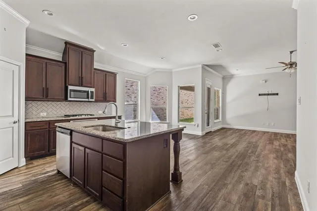 a kitchen with stainless steel appliances granite countertop a stove and a sink