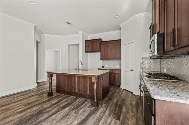 a kitchen with a sink stove and cabinets