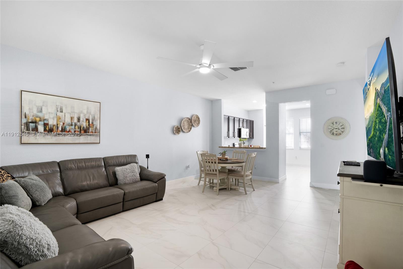 2565 Southwest 119th Terrace Miramar, FL 33025 - Photo 11 of 37 a living room with furniture and a wooden floor