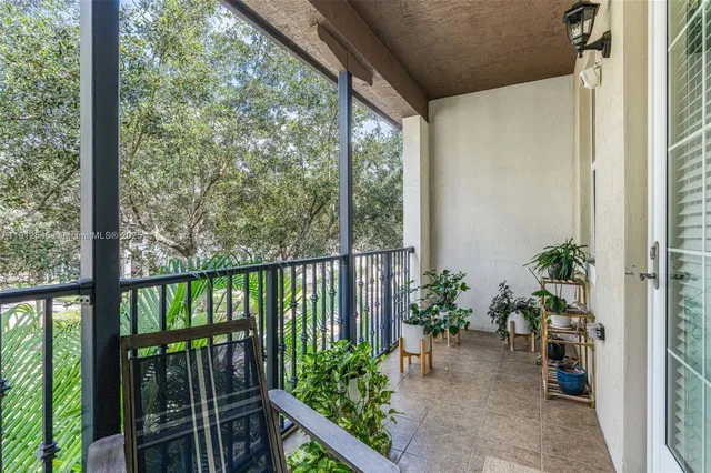 a view of a balcony with potted plants