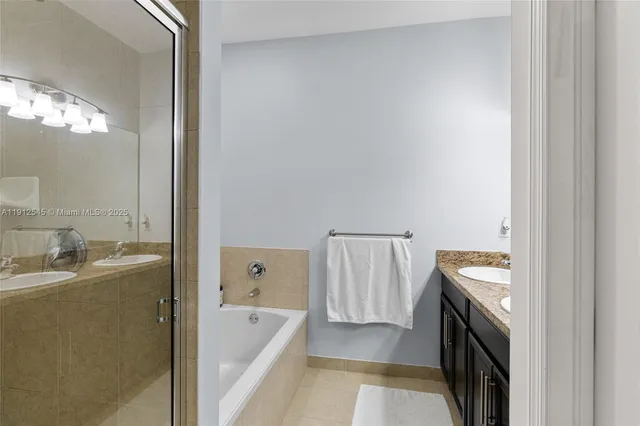 a bathroom with a tub sink and mirror