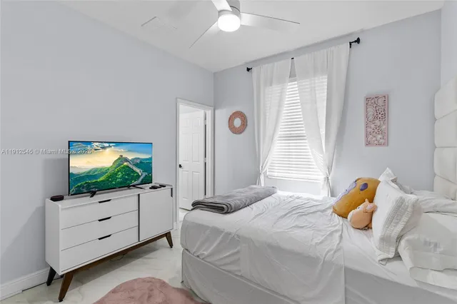a bedroom with a bed and flat screen tv