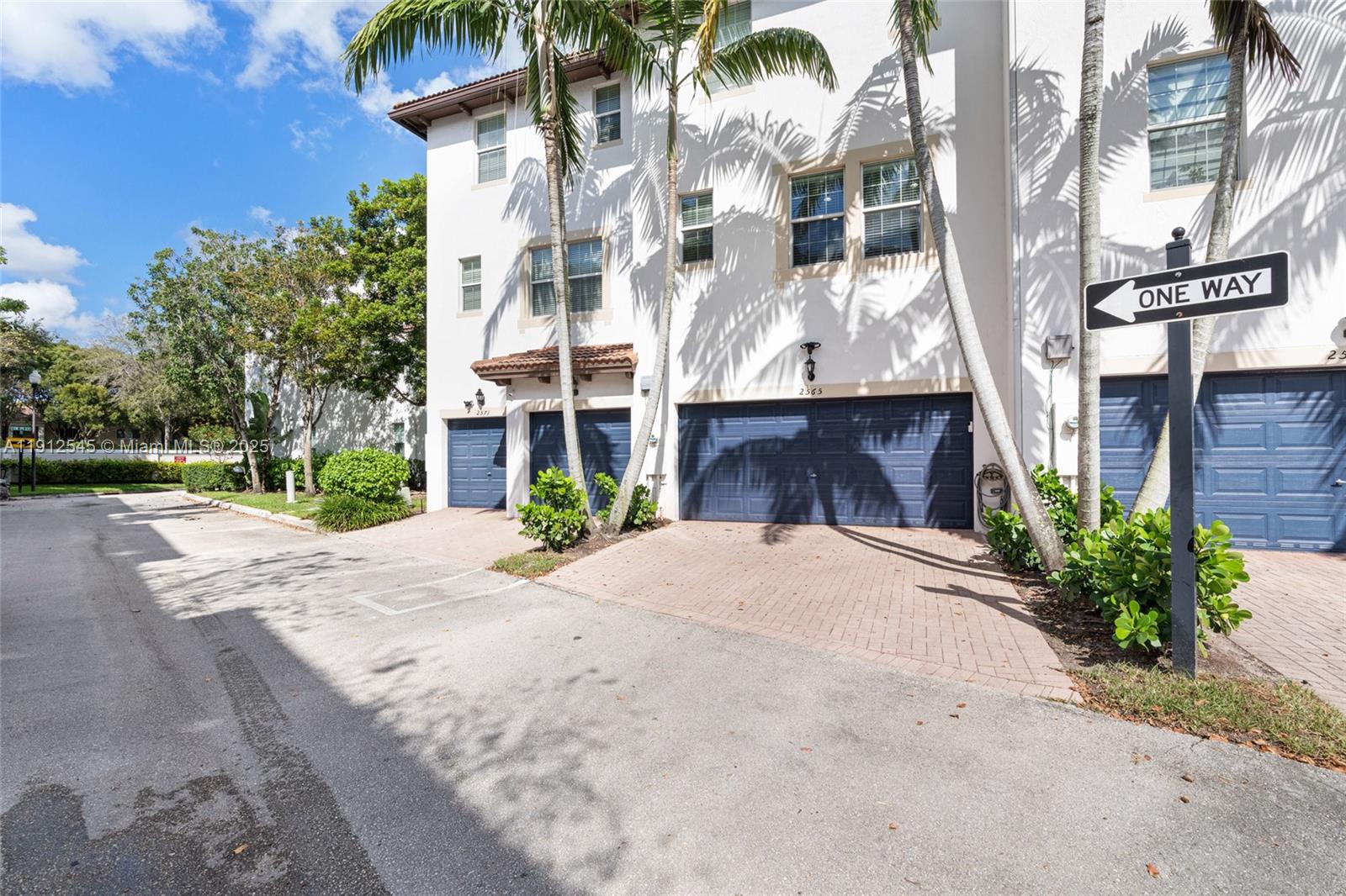 2565 Southwest 119th Terrace Miramar, FL 33025 - Photo 29 of 37 a front view of a building with palm trees