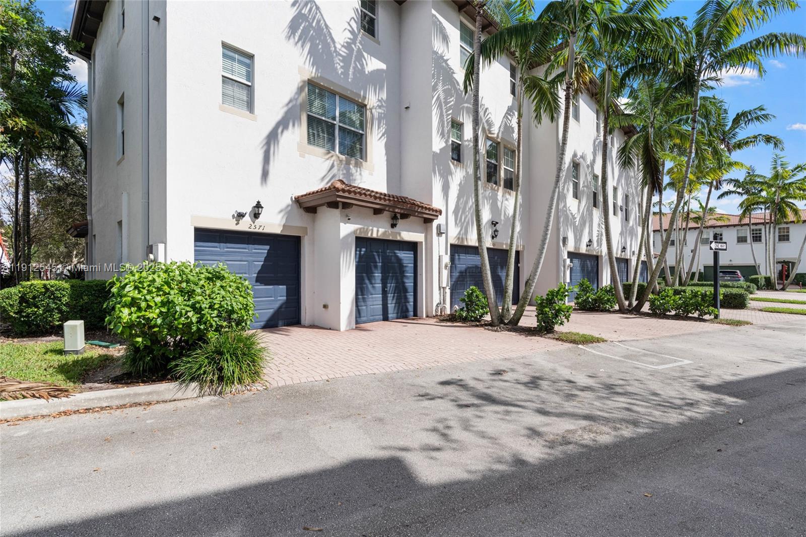 2565 Southwest 119th Terrace Miramar, FL 33025 - Photo 30 of 37 a front view of a building with palm trees