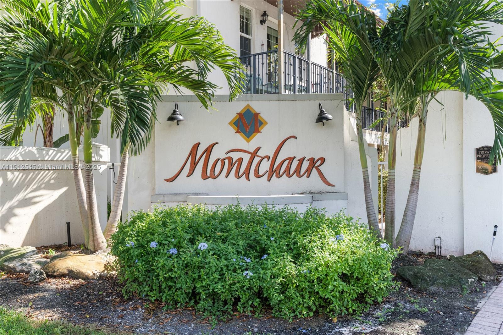 2565 Southwest 119th Terrace Miramar, FL 33025 - Photo 3 of 37 a view of a sign under a tree next to a building