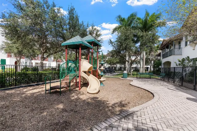 a view of a park with swings and slides