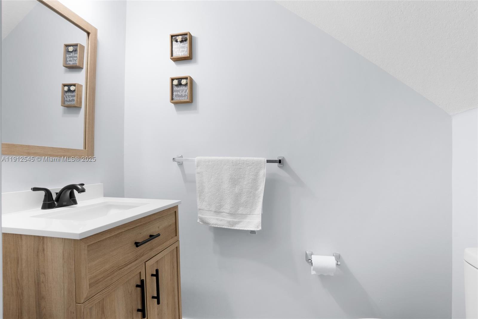 2565 Southwest 119th Terrace Miramar, FL 33025 - Photo 7 of 37 a bathroom with a sink and a mirror