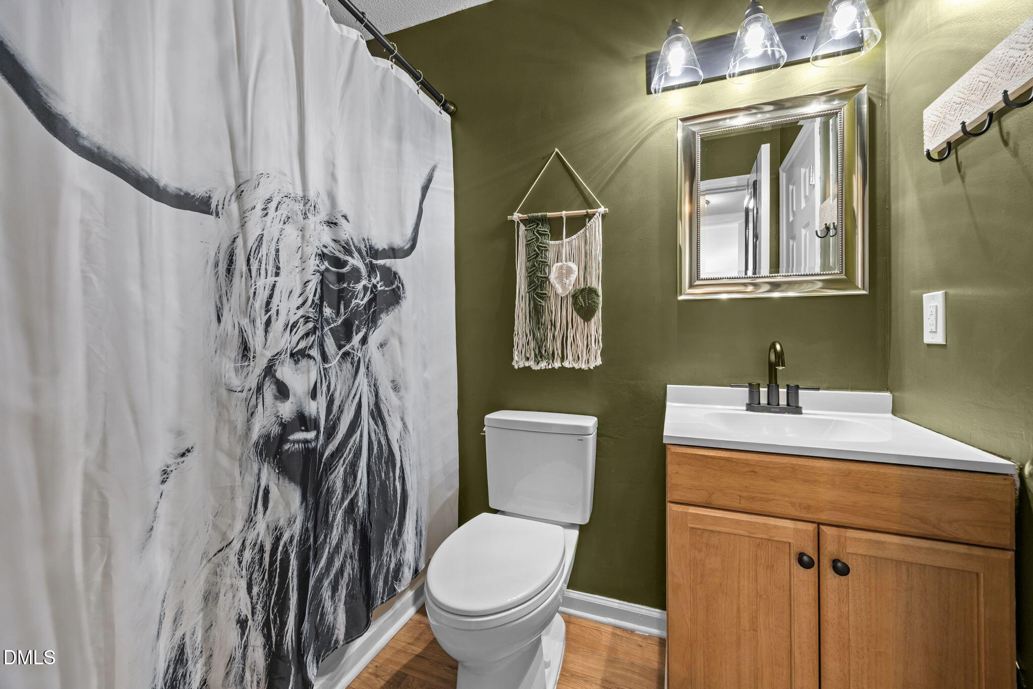 440 Dickens Drive Raleigh, NC 27610 - Photo 12 of 18 a bathroom with a toilet sink and mirror