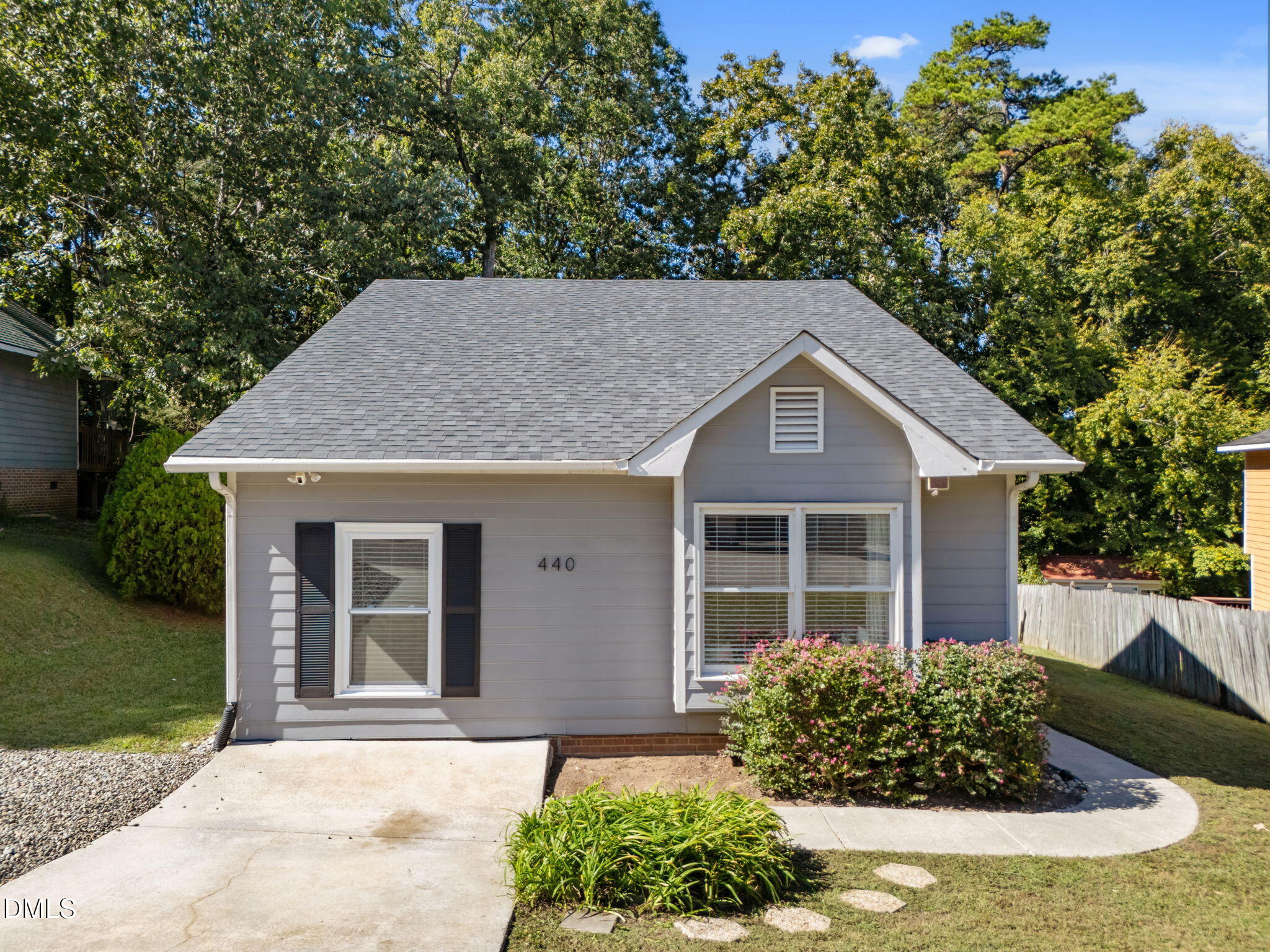 440 Dickens Drive Raleigh, NC 27610 - Photo 16 of 18 a view of a house with brick walls and a yard with plants