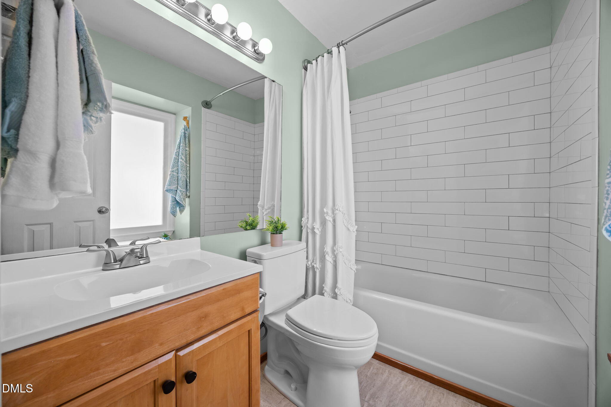 440 Dickens Drive Raleigh, NC 27610 - Photo 7 of 18 a bathroom with a sink a toilet window and shower