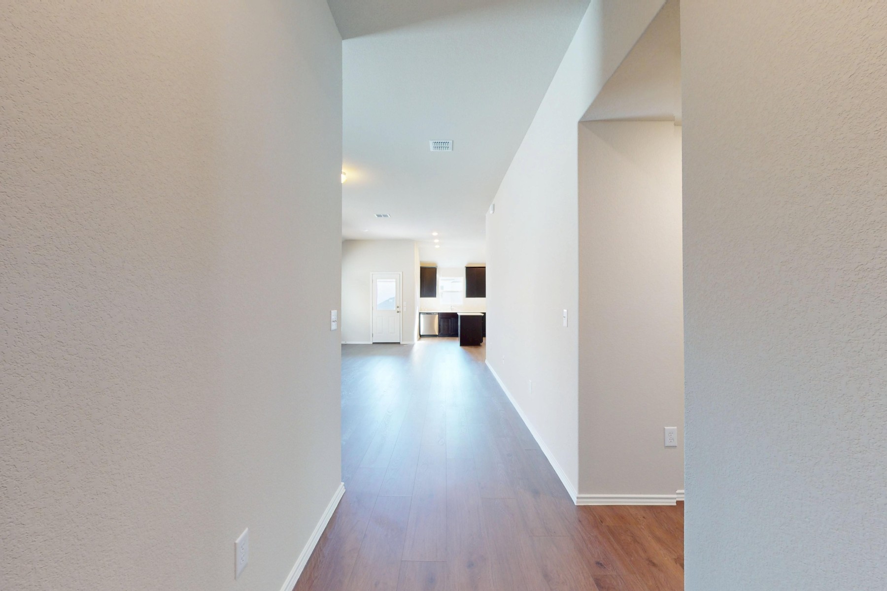11917 Dillon Fls Drive Austin, TX 78747 - Photo 15 of 38 a view of a hallway with wooden floor and a living room