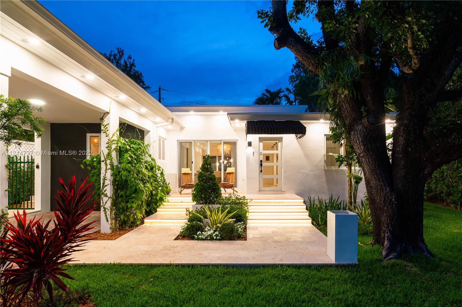 3731 Battersea Road Miami, FL 33133 - Photo 1 of 44 a front view of a house with garden