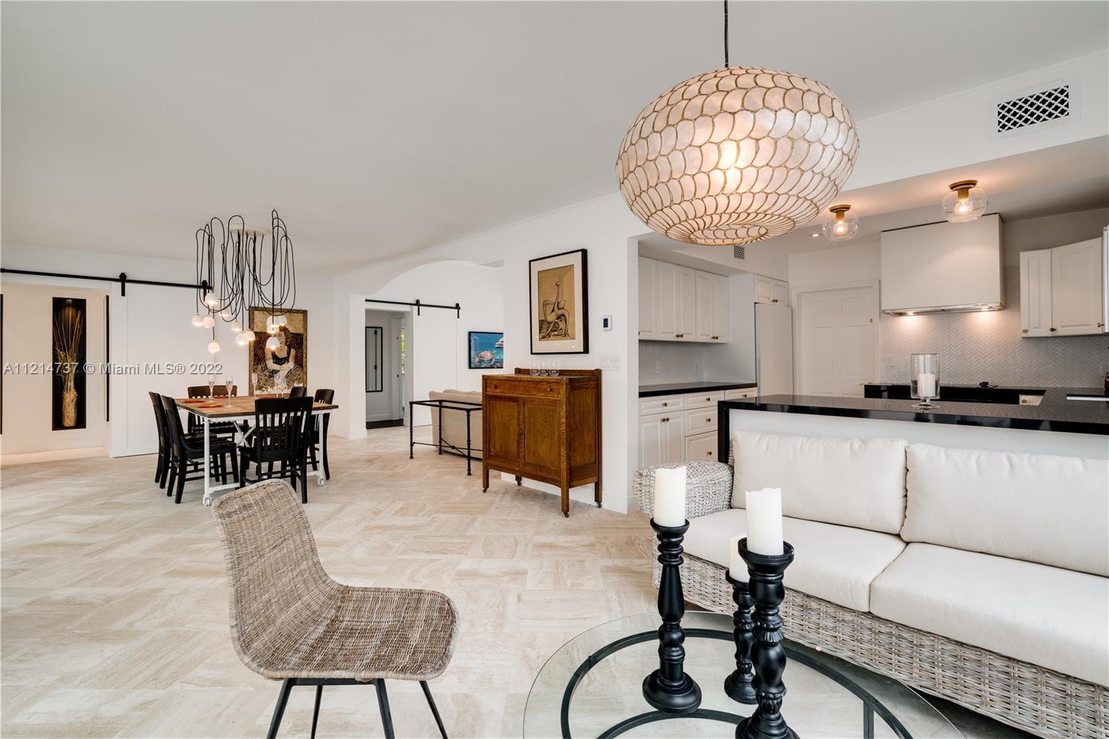 3731 Battersea Road Miami, FL 33133 - Photo 12 of 44 a living room with furniture a chandelier and a chandelier